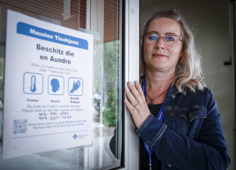Tina Meggison, a community health rep for the Low German Mennonite community in southern Alberta, is seen with a sign in Low German at the Taber Community Health Clinic in Taber, Alta., Monday, July 28, 2025. THE CANADIAN PRESS/Jeff McIntosh
