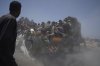FILE - Palestinians hold onto an aid truck returning to Gaza City from the northern Gaza Strip on Tuesday, July 22, 2025. (AP Photo/Jehad Alshrafi, file)
