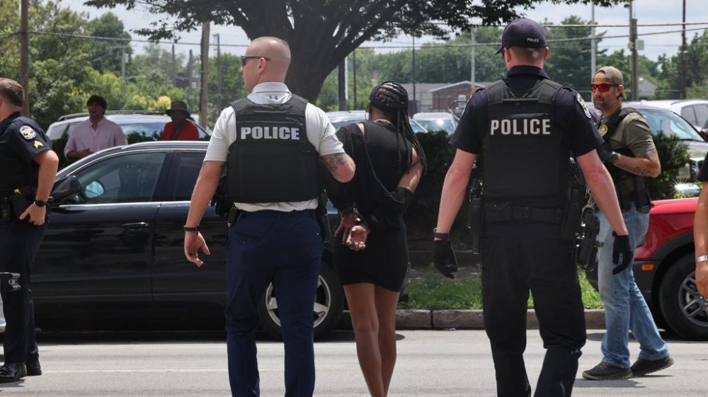 In this photo provided by WHAS-11 News, a protestor is seen detained by police outside the federal courthouse where ex-Kentucky police officer Brett Hankison, convicted of using excessive force during the deadly Breonna Taylor raid, is taking place, Monday, July 21, 2025, in Louisville, Ky. (Alyssa Newton/WHAS-11 News via AP)