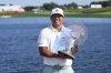 Kurt Kitayama holds his trophy after winning the 3M Open golf tournament at the Tournament Players Club Sunday, July 27, 2025, in Blaine, Minn. (AP Photo/Abbie Parr)