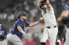 Tampa Bay Rays' Jonathan Aranda tags out New York Yankees' Austin Wells during the ninth inning of a baseball game Wednesday, July 30, 2025, in New York. (AP Photo/Frank Franklin II)