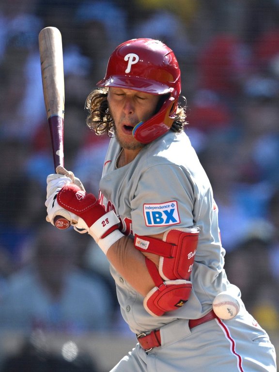 Philadelphia Phillies' Alec Bohm is hit by a pitch during the first inning of a baseball game against the San Diego Padres, Saturday, July 12, 2025, in San Diego. (AP Photo/Orlando Ramirez)