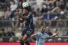 Philadelphia Union's Nathan Harriel, left, leaps for the ball past CF Montréal's Luca Petrasso during the first half of an MLS soccer match, Wednesday, July 16, 2025, in Chester, Pa. (AP Photo/Matt Slocum)