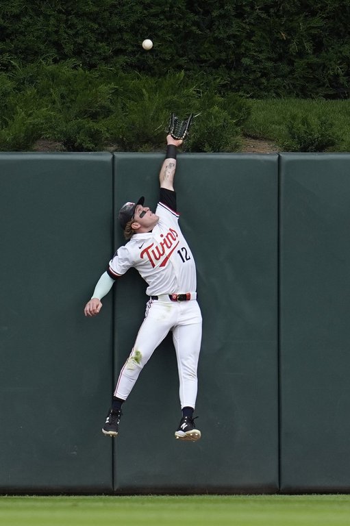 Minnesota Twins center fielder Harrison Bader tries to catch a two-run home run by Chicago Cubs' Pete Crow-Armstrong during the third inning of a baseball game, Thursday, July 10, 2025, in Minneapolis. (AP Photo/Abbie Parr)