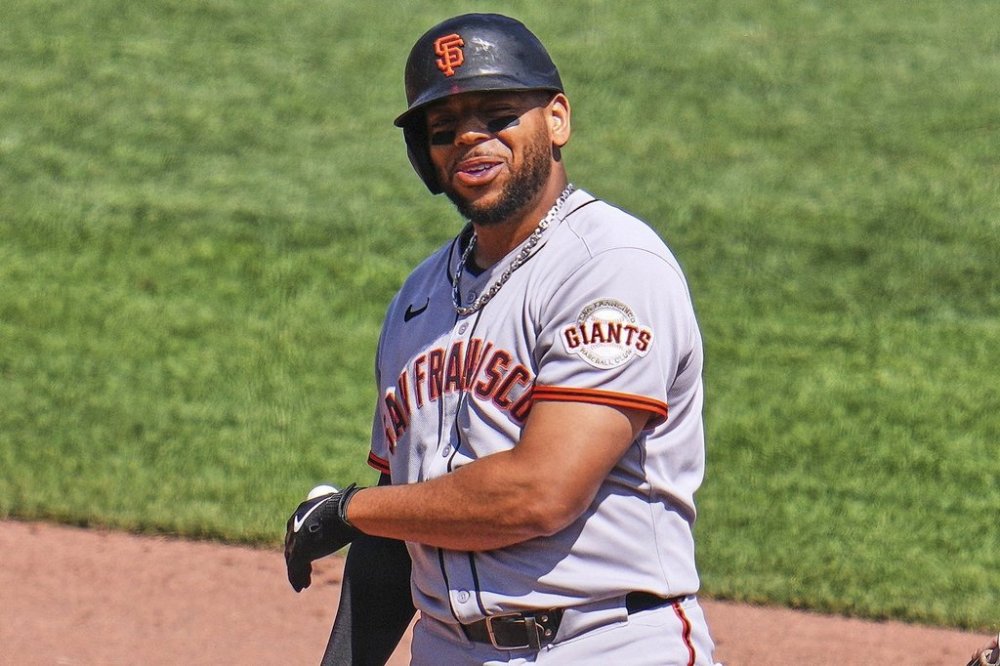 San Francisco Giants' Dominic Smith celebrates as he stands on second base after driving in a run with a double off Pittsburgh Pirates pitcher Dennis Santana during the ninth inning of a baseball game in Pittsburgh, Wednesday, Aug. 6, 2025. (AP Photo/Gene J. Puskar)
