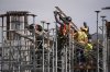 Construction workers work at the site of a condo tower under construction, in Delta, B.C., on Wednesday, July 2, 2025. Six months after U.S. President Donald Trump's return the White House, many in the home construction sector say unpredictability persists around the cost and timing of obtaining the materials they need. THE CANADIAN PRESS/Darryl Dyck