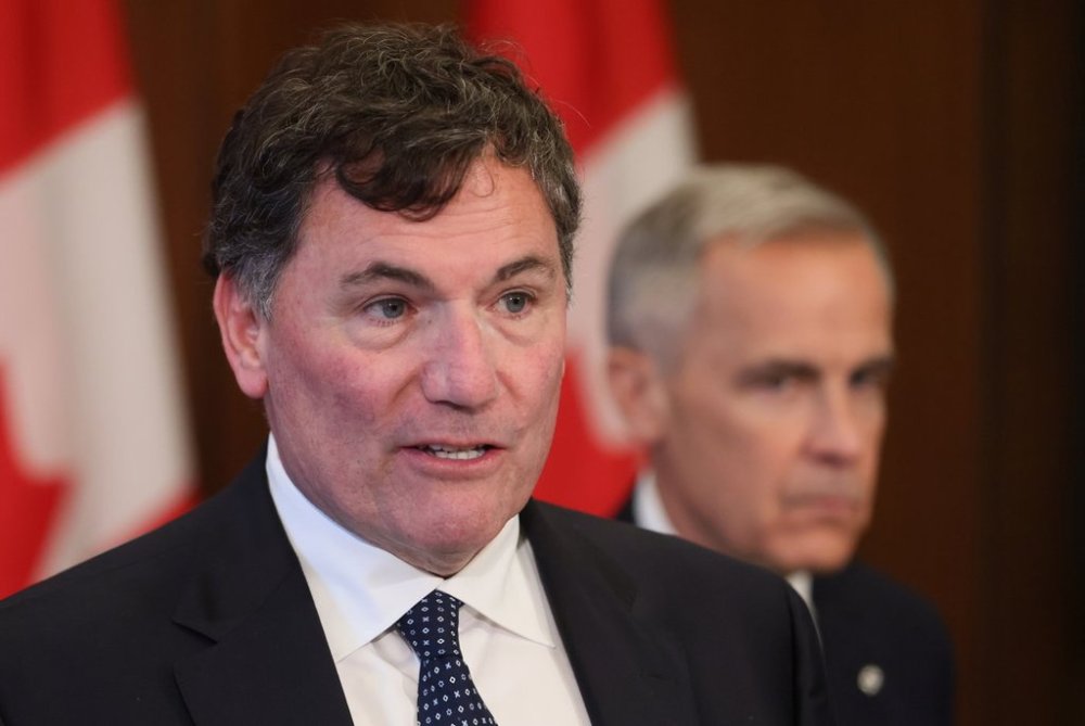 President of the King’s Privy Council for Canada Dominic LeBlanc speaks at a press conference while Prime Minister Mark Carney listens, on Parliament Hill in Ottawa, Thursday, June 19, 2025. THE CANADIAN PRESS/Patrick Doyle
