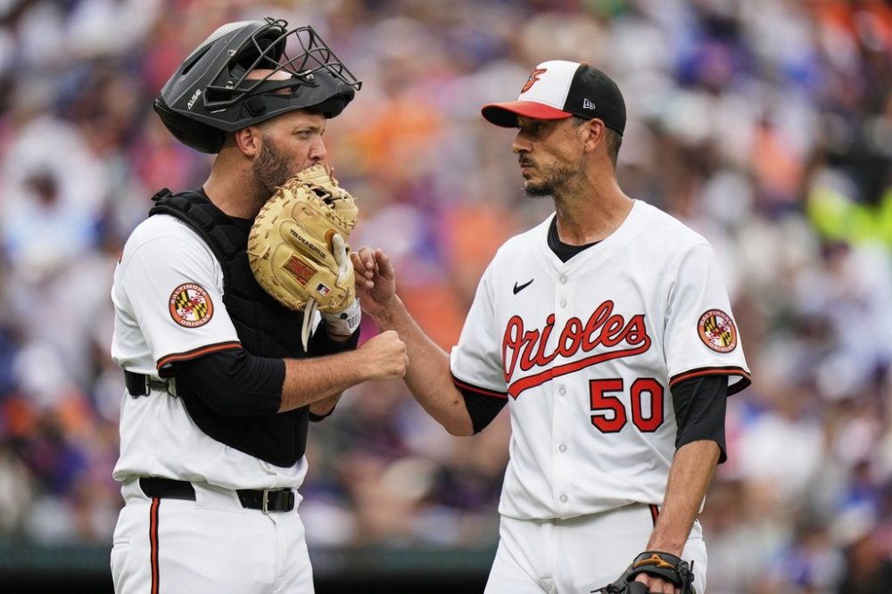 Baltimore Orioles starting pitcher Charlie Morton (50) celebrates with Baltimore Orioles catcher Jacob Stallings, left, after closing out the third inning in the first baseball game of a doubleheader against the New York Mets, Thursday, July 10, 2025, in Baltimore. (AP Photo/Stephanie Scarbrough)