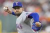 Texas Rangers starting pitcher Nathan Eovaldi throws against the Houston Astros during the first inning of a baseball game Sunday, July 13, 2025, in Houston. (AP Photo/David J. Phillip)