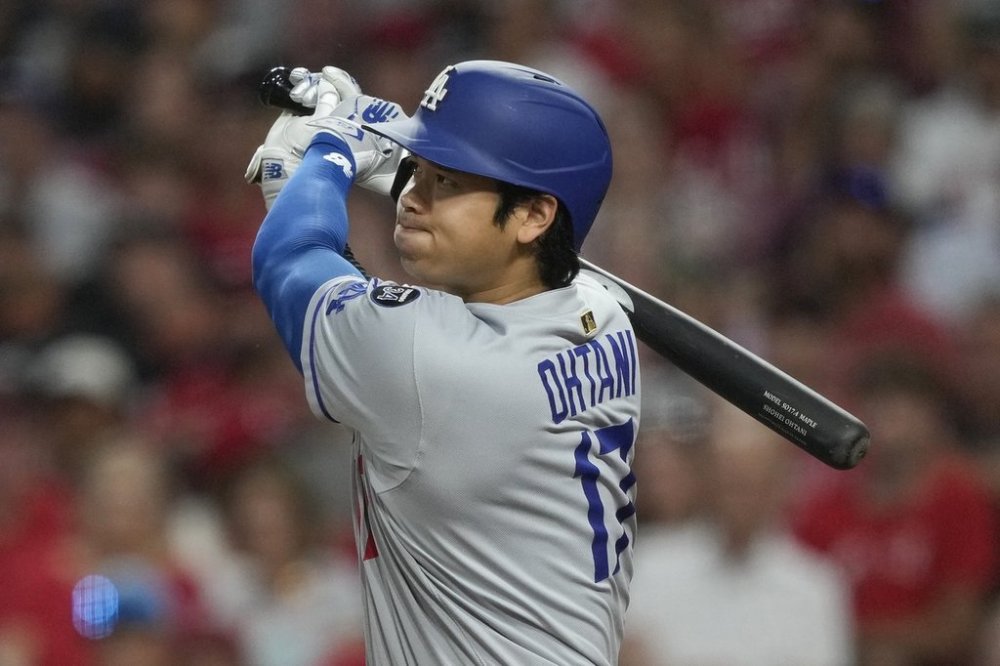 Los Angeles Dodgers' Shohei Ohtani watches his double to score Miguel Rojas and Mookie Betts during the fifth inning of a baseball game against the Cincinnati Reds, Monday, July 28, 2025, in Cincinnati. (AP Photo/Carolyn Kaster)