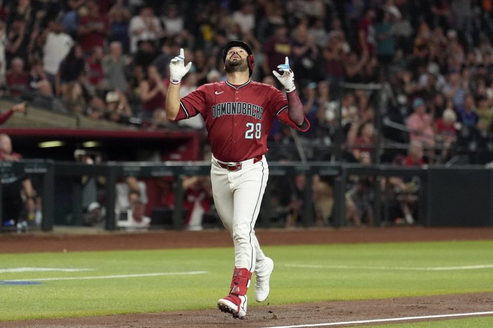 Arizona Diamondbacks' Eugenio Suárez looks up as he rounds the bases after hitting a home run against the Houston Astros during the third inning of a baseball game Monday, July 21, 2025, in Phoenix. (AP Photo/Ross D. Franklin)