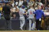 Chicago Cubs' Ian Happ (8) is helped off the field by a trainer and manager Craig Counsell (11) after suffering an injury during the eighth inning of a baseball game against the Milwaukee Brewers, Tuesday, July 29, 2025, in Milwaukee. (AP Photo/Aaron Gash)