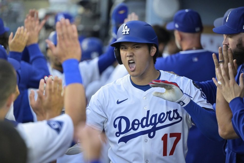 Los Angeles Dodgers' Shohei Ohtani (17) is congratulated by teammates after hitting a two-run home run against the Minnesota Twins during the first inning of a baseball game in Los Angeles, Monday, July 21, 2025. (AP Photo/Jayne Kamin-Oncea)