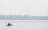 A man fishes on Lake St. Louis, Friday, June 30, 2023 in Lachine, Que. Environment Canada says forest fires are causing poor air quality today across much of the country, including Quebec. THE CANADIAN PRESS/Christinne Muschi