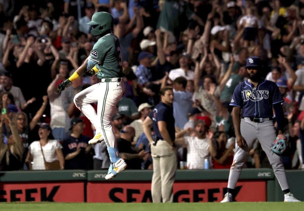 Boston Red Sox's Ceddanne Rafaela, left, reacts after hitting a two-run walkoff home run during the ninth inning of a baseball game against the Tampa Bay Rays, Friday, July 11, 2025, in Boston. (AP Photo/Mark Stockwell)