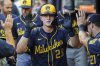Milwaukee Brewers' Andrew Vaughn (28) high-fives teammates in the dugout after hitting a solo home run in the fourth inning of a baseball game against the Atlanta Braves, Wednesday, Aug. 6, 2025, in Atlanta. (AP Photo/Colin Hubbard)