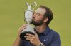 Scottie Scheffler of the United States kisses the trophy as he poses for photographers with the Claret Jug after winning the British Open golf championship at the Royal Portrush Golf Club, Northern Ireland, Sunday, July 20, 2025. (AP Photo/Francisco Seco)