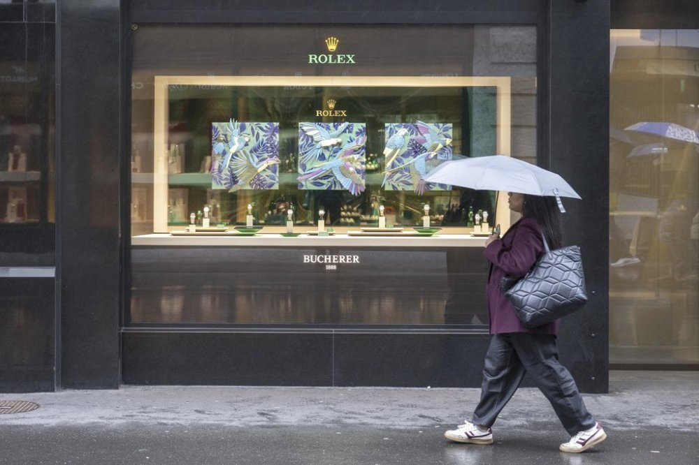 A woman walks by a store selling Rolex watches, on Grendelstrasse, Wednesday, April 16, 2025 in Lucerne, Switzerland. (Urs Flueeler/Keystone via AP)