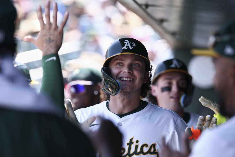 Athletics' Nick Kurtz celebrates in the dugout after hitting a two-run home run during the fifth inning of a baseball game against the Toronto Blue Jays, Sunday, July 13, 2025, in West Sacramento, Calif. (AP Photo/Sara Nevis)