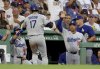 Los Angeles Dodgers designated hitter Shohei Ohtani (17) celebrates his run with a high five to manager Dave Roberts, right, during the third inning of a baseball game against the Boston Red Sox, Friday, July 25, 2025, in Boston. (AP Photo/Mark Stockwell)