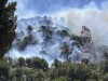 This photo provided by the fire brigade SDIS13, smoke rises during a wildfire in Pennes-Mirabeau, near Marseille, southern France, Tuesday, July 8, 2025. (SDIS13 via AP)
