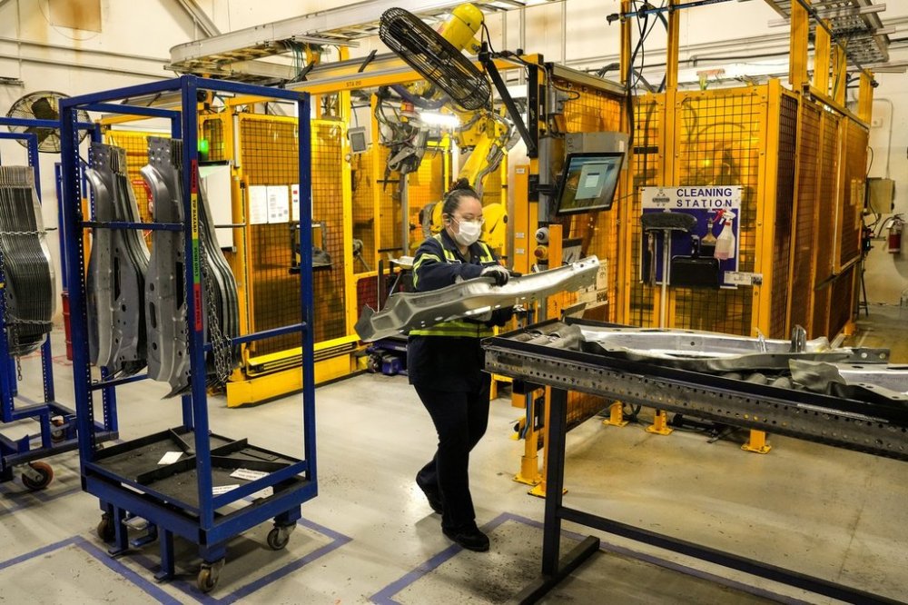 An employee works on the production line at the Martinrea auto parts manufacturing plant in Woodbridge, Ontario on Monday February 3, 2025. THE CANADIAN PRESS/Chris Young
