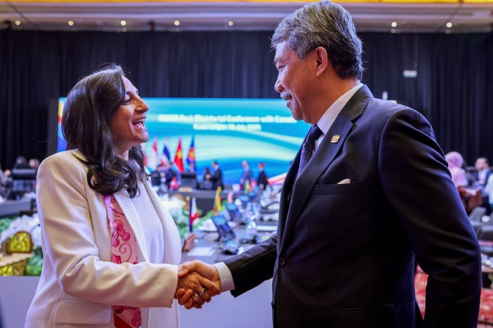 Malaysia's Foreign Minister Mohamad Hasan, right, greets Foreign Minister Anita Anand during the Association of Southeast Asian Nations (ASEAN) Post-Ministerial Conference with Canada, held as part of the 58th ASEAN Foreign Ministers' Meeting and related meetings, at the Kuala Lumpur Convention Centre on Thursday, July 10, 2025. (Bernama via AP)