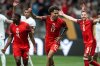 Canada's Tajon Buchanan (17) celebrates his goal against Honduras with Kamal Miller (4) and Mathieu Choiniere (6) during the second half of a CONCACAF Gold Cup soccer match in Vancouver, on Tuesday, June 17, 2025. THE CANADIAN PRESS/Ethan Cairns