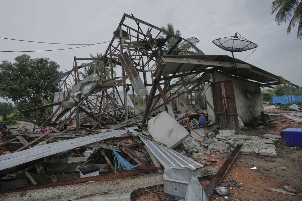 A house is seen damaged after Cambodia fired artillery shells in Surin Province, Thailand, Sunday, July 27, 2025. (AP Photo/Sakchai Lalit)