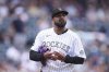 Colorado Rockies starting pitcher Germán Márquez reacts after giving up a single to Minnesota Twins' Kody Clemens to load the bases in the first inning of a baseball game Sunday, July 20, 2025, in Denver. (AP Photo/David Zalubowski)