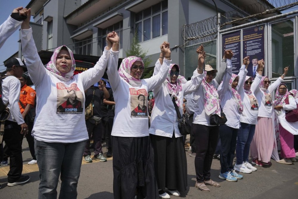 Supporters of Indonesia's former Trade Minister Tom Lembong, who was sentenced to more than four years in prison gather in front of the gate of Cipinang prison in Jakarta, Indonesia, Friday, Aug. 1, 2025 as the country prepares to release hundreds of prisoners under president's clemency plan. (AP Photo/Achmad Ibrahim)