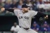 New York Yankees relief pitcher David Bednar throws to the Texas Rangers in the eighth inning of a baseball game Wednesday, Aug. 6, 2025, in Arlington, Texas. (AP Photo/Tony Gutierrez)