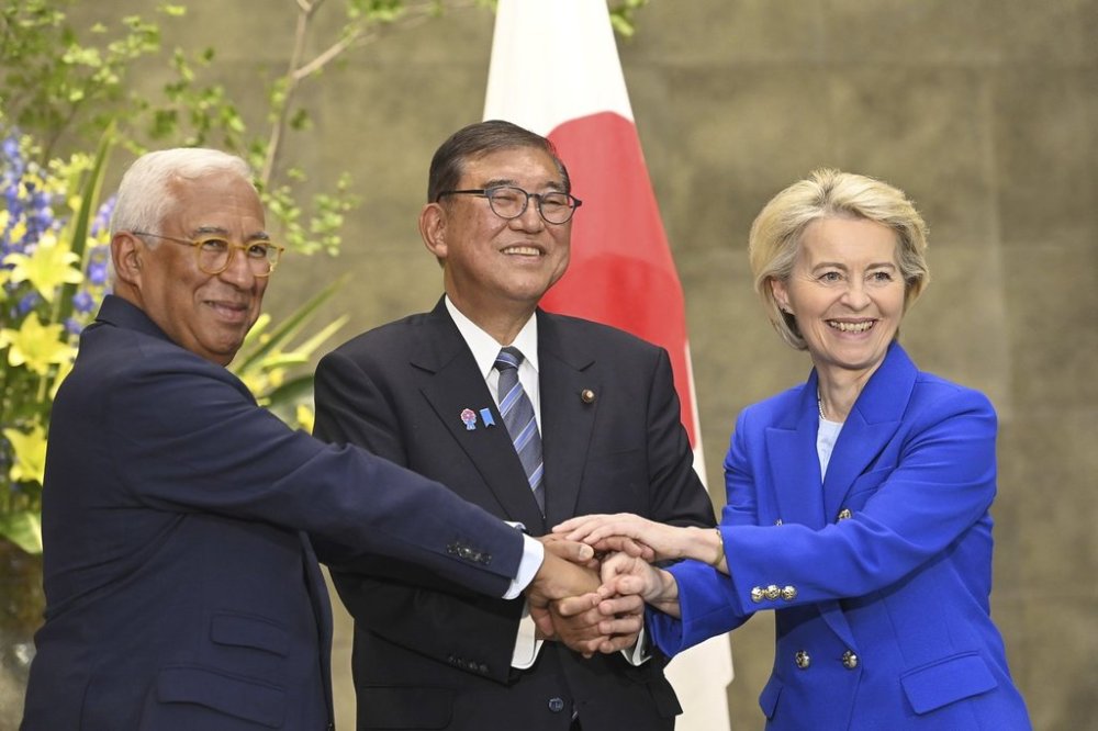 European Commission President Ursula von der Leyen, right, Japanese Prime Minister Shigeru Ishiba, center, and European Council President António Costa, left, join hands prior a meeting at the prime minister’s office Wednesday, July 23, 2025, in Tokyo Japan. (David Mareuil/Pool Photo via AP)
