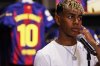 FC Barcelona player Lamine Yamal wears a pendant bearing the number 10—his new jersey number—during a press event following a contract extension with the soccer club in Barcelona, northern Spain, Wednesday, July 16, 2025. (AP Photo/Joan Monfort)