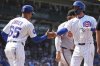 Chicago Cubs' Dansby Swanson, front right, celebrates with first base coach Jose Javier (65) after hitting a one-run single during the sixth inning of a baseball game against the Baltimore Orioles in Chicago, Sunday, Aug. 3, 2025. (AP Photo/Nam Y. Huh)