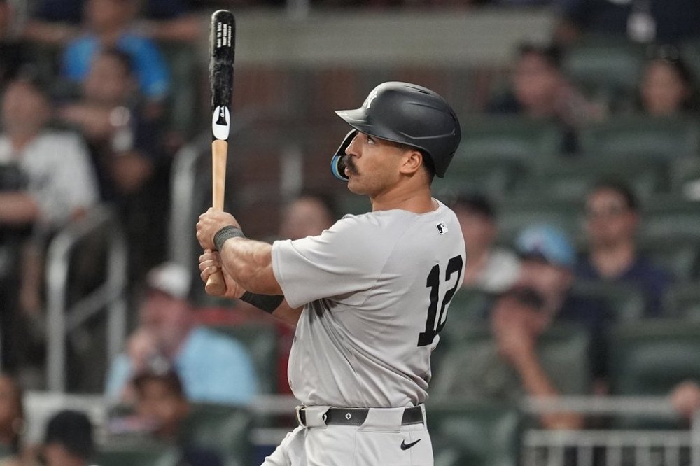 New York Yankees' Trent Grisham (12) hits a grand slam home run against the Atlanta Braves in the ninth inning of a baseball game, Saturday, July 19, 2025, in Atlanta. (AP Photo/Mike Stewart)