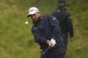 Shane Lowry of Ireland chips onto the 7th green during the first round of the British Open golf championship at the Royal Portrush Golf Club, Northern Ireland, Thursday, July 17, 2025. (AP Photo/Francisco Seco)