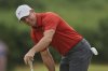 Rory McIlroy of Northern Ireland reacts on the 2nd green after putting during the third round of the British Open golf championship at the Royal Portrush Golf Club, Northern Ireland, Saturday, July 19, 2025. (AP Photo/Peter Morrison)