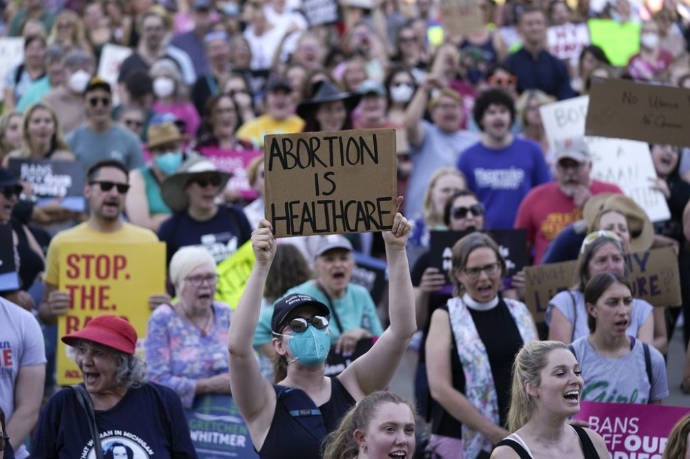 FILE - Abortion-rights protesters demonstrate against the United States Supreme Court's decision to overturn Roe v. Wade, federally protected right to abortion, outside the state capitol in Lansing, Michigan, June 24, 2022. (AP Photo/Paul Sancya, File)