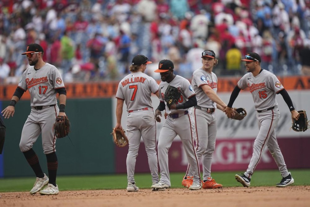 Members of the Baltimore Orioles celebrate after winning a baseball game against the Philadelphia Phillies, Wednesday, Aug. 6, 2025, in Philadelphia. (AP Photo/Matt Rourke)