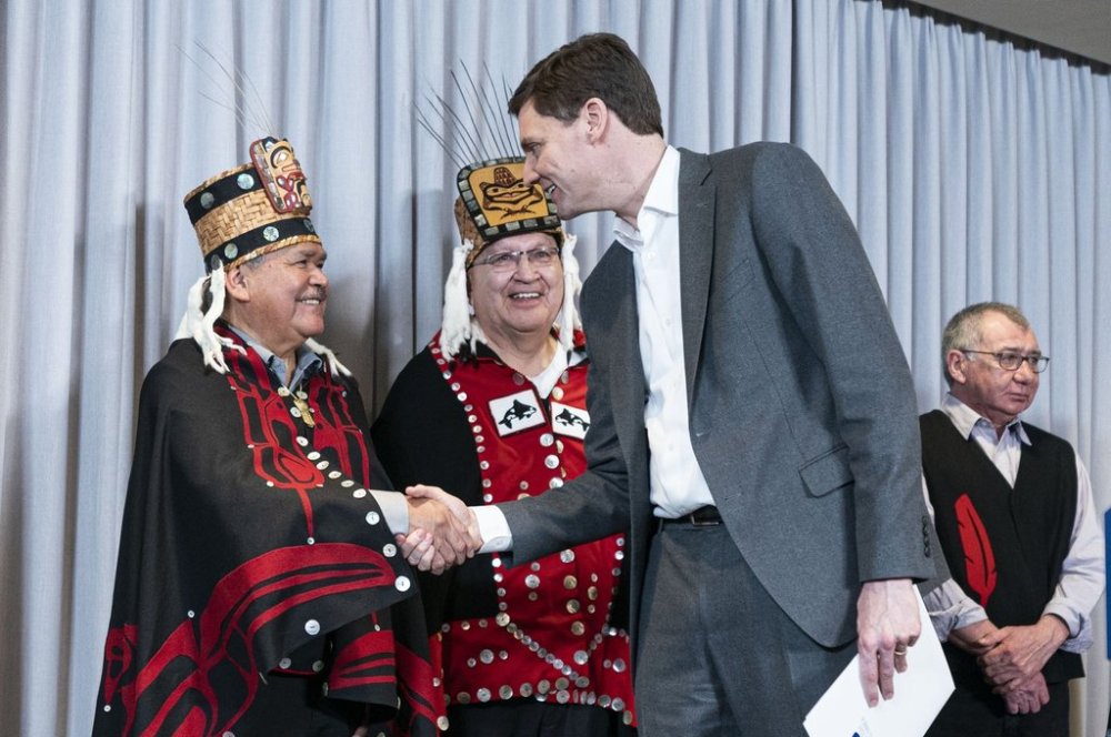 BC Premier David Eby, right, shakes the hand of Hereditary Chief of the Haisla Nation Jake Duncan, left, as Hereditary Chief Basil Grant looks on after a press conference announcing that the Cedar LNG project has been given environmental approval in Vancouver, Tuesday March 14, 2023. THE CANADIAN PRESS/Rich Lam