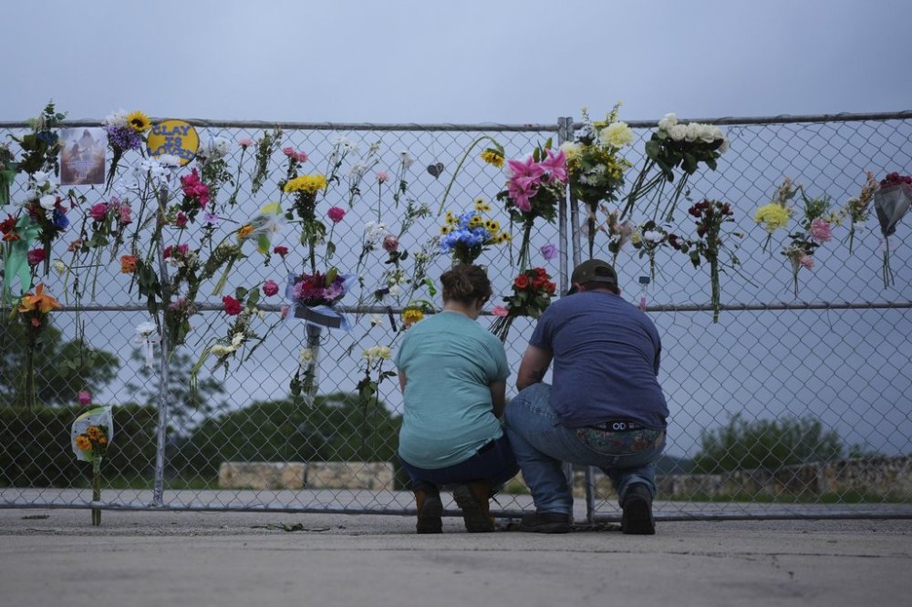 Visitors place items on a memorial wall for flood victims, Sunday, July 13, 2025, in Kerrville, Texas. (AP Photo/Eric Gay)