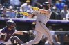 Pittsburgh Pirates' Spencer Horwitz grounds out to drive in a run as Colorado Rockies catcher Hunter Goodman covers his position in the eighth inning of a baseball game, Sunday, Aug. 3, 2025, in Denver. (AP Photo/David Zalubowski)