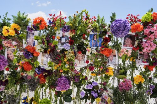 Photographs of flood victims are displayed on a memorial wall in Kerrville, Texas, Thursday, July 10, 2025. (AP Photo/Ashley Landis)