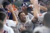 Houston Astros' Jose Altuve celebrates in the dugout after hitting a three-run home run against the Washington Nationals during the second inning of a baseball game Wednesday, July 30, 2025, in Houston. (AP Photo/David J. Phillip)