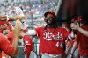 Cincinnati Reds' Elly De La Cruz (44) is greeted by teammates in the dugout after scoring on a single hit by Gavin Lux off Washington Nationals pitcher Jake Irvin during the fourth inning of a baseball game in Washington, Monday, July 21, 2025. (AP Photo/Terrance Williams)