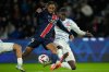FILE - PSG's Bradley Barcola, center, is challenged by Strasbourg's Mamadou Sarr, right, and Diego Moreira during the French League One soccer match between Paris Saint-Germain and Strasbourg at the Parc des Princes in Paris, Oct. 19, 2024. (AP Photo/Christophe Ena, File)