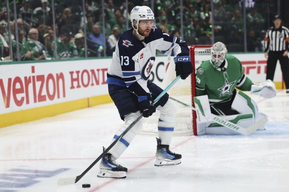 Winnipeg Jets centre Gabriel Vilardi prepares to make a pass as Dallas Stars goaltender Jake Oettinger, right rear, looks on in the second period of Game 4 of a second-round NHL hockey playoff series in Dallas, Tuesday, May 13, 2025. (AP Photo/Gareth Patterson)