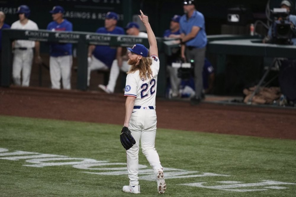 Texas Rangers relief pitcher Jon Gray celebrates after center fielder Michael Helman made a leaping catch on a fly out by Athletics' Tyler Soderstrom in the sixth inning of a baseball game, Wednesday, July 23, 2025, in Arlington, Texas. (AP Photo/Tony Gutierrez)