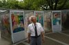 Kunihio Iida, atomic bomb survivor and a volunteer guide speaks in English to foreign visitors looks app the sky in front of the Children's Peace Monument where the place where people offer paper cranes to honor the victims of the 1945 atomic bomb on Wednesday, July 9, 2025, in Hiroshima, western Japan. (AP Photo/Eugene Hoshiko)